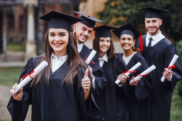 Graduates throwing caps in the air on graduation day